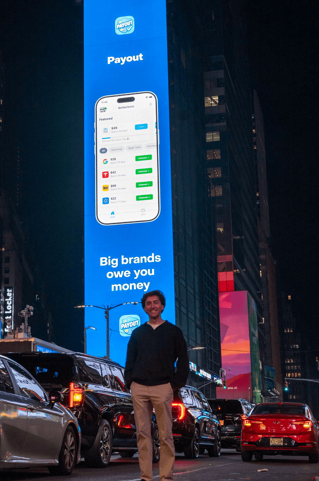 Connor in front of his app's Times Square billboard